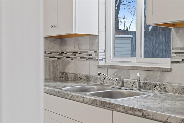 kitchen featuring white cabinetry and sink