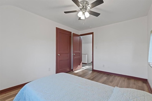 bedroom with hardwood / wood-style floors and ceiling fan