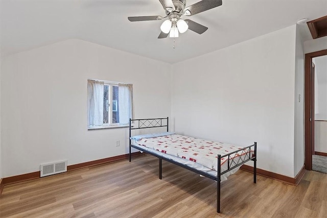 bedroom featuring light hardwood / wood-style flooring, ceiling fan, and lofted ceiling