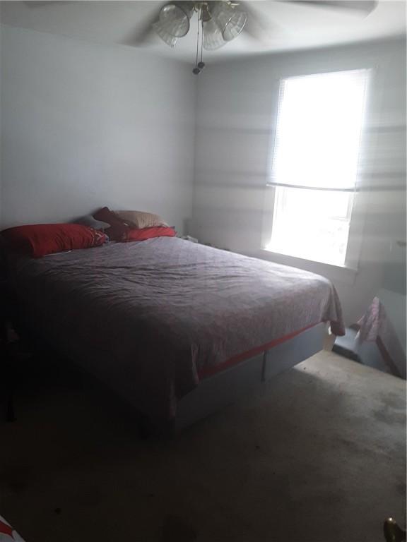 bedroom featuring multiple windows and ceiling fan