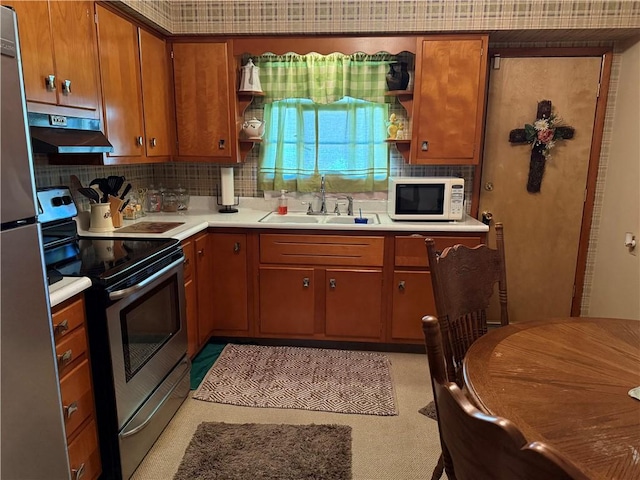 kitchen with appliances with stainless steel finishes, tasteful backsplash, and sink