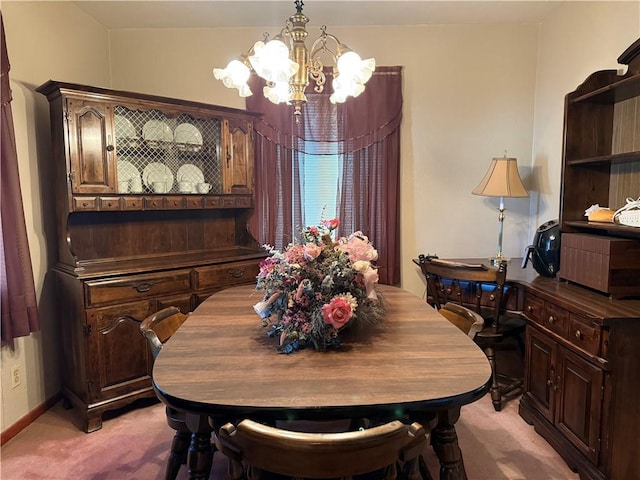 carpeted dining space with a chandelier