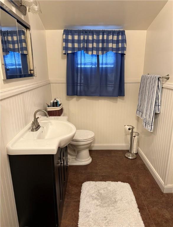 bathroom with tile patterned flooring, vanity, and toilet