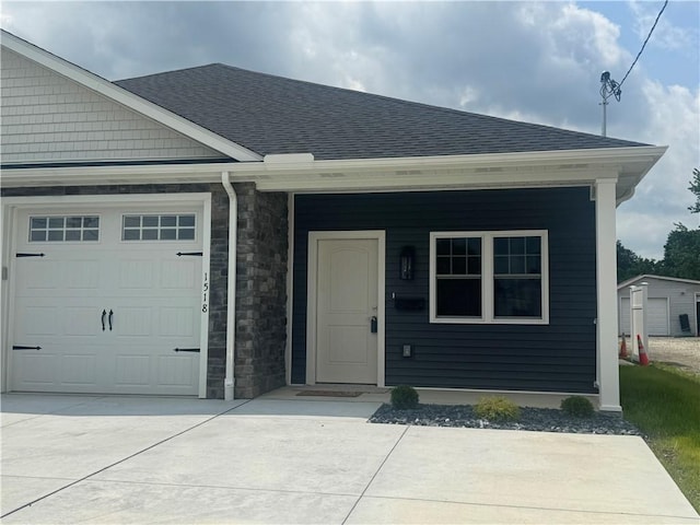 1518 Marshall Rd, Monaca, PA 15061 - view of front facade with a garage, a shingled roof, driveway, and stone siding