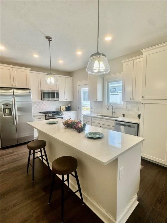 1518 Marshall Rd, Monaca, PA 15061 - kitchen with appliances with stainless steel finishes, a sink, a kitchen island, white cabinetry, and tasteful backsplash