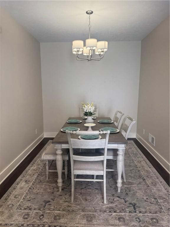 1518 Marshall Rd, Monaca, PA 15061 - dining area with a chandelier, baseboards, and dark wood-style flooring