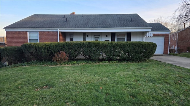 single story home with a garage and a front lawn