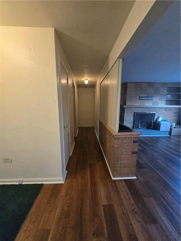 corridor featuring dark wood-type flooring