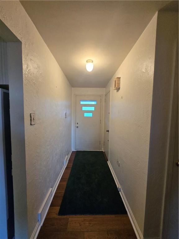 doorway to outside featuring dark wood-type flooring