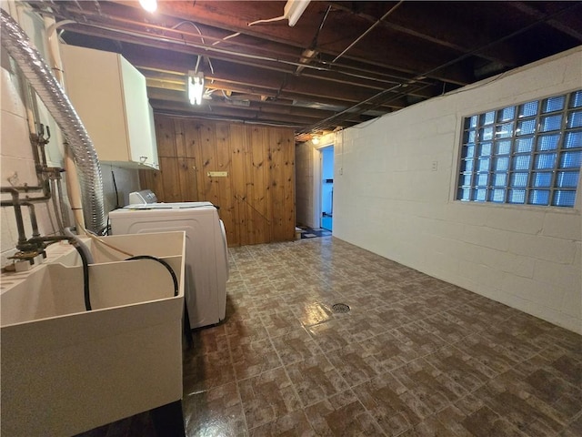 washroom with wooden walls, cabinets, and washer / clothes dryer