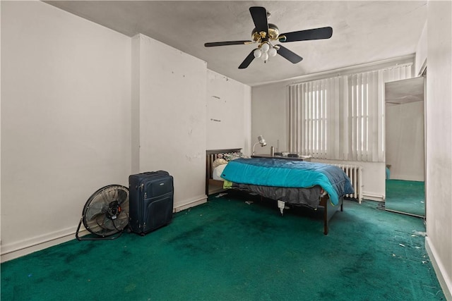 unfurnished bedroom featuring carpet flooring, ceiling fan, and radiator