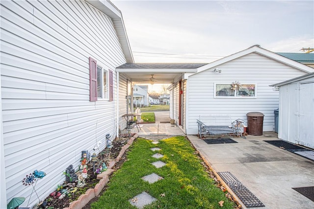 exterior space with a shed and ceiling fan