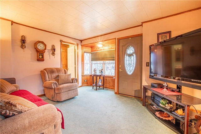 living room with wood walls, carpet floors, and ornamental molding