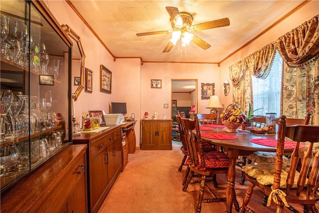 carpeted dining area featuring ceiling fan and ornamental molding