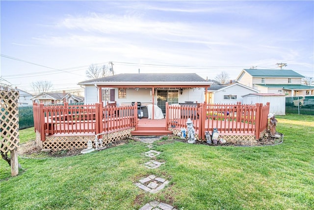 rear view of house featuring a yard and a deck