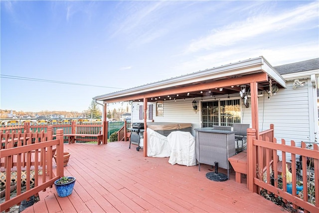 wooden deck featuring a hot tub