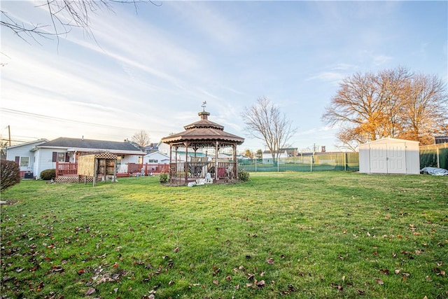 view of yard with a gazebo and a storage unit