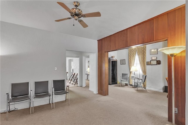 interior space featuring ceiling fan and light colored carpet