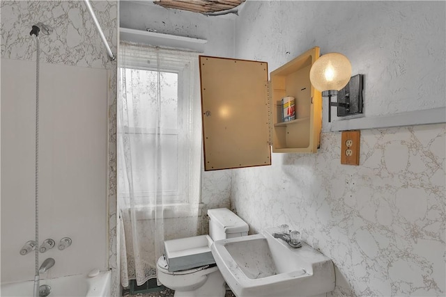 full bathroom featuring tile walls, sink, bathtub / shower combination, and toilet