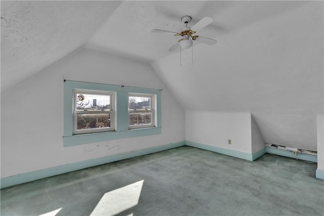 bonus room with light carpet, vaulted ceiling, and ceiling fan