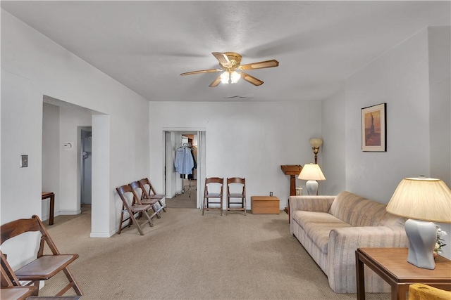 carpeted living room featuring ceiling fan