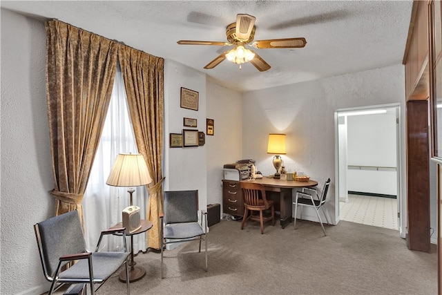 sitting room with ceiling fan, carpet, and a textured ceiling