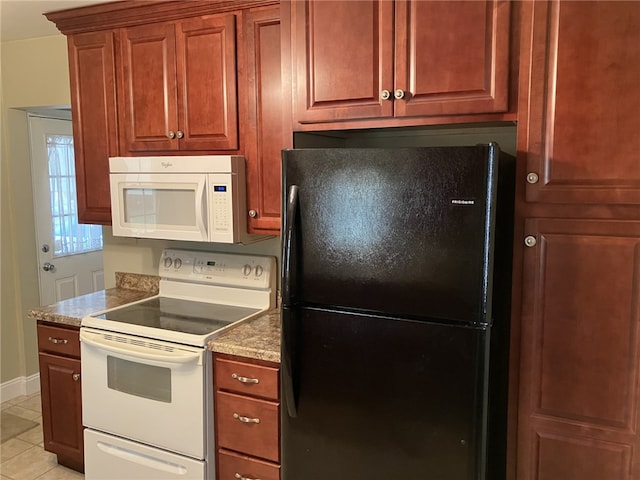 kitchen with light tile patterned floors and white appliances