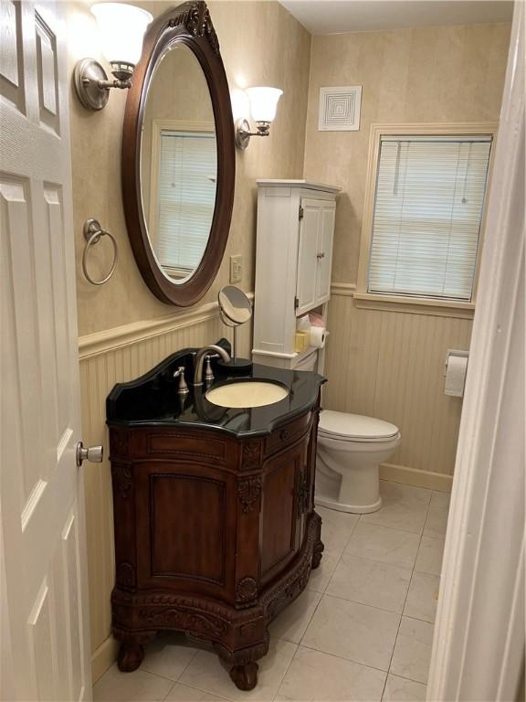 bathroom featuring tile patterned flooring, vanity, and toilet