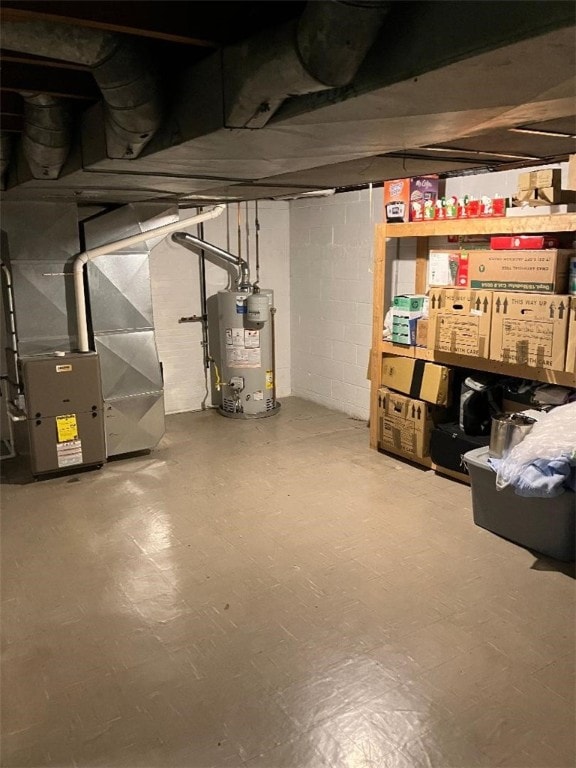 basement featuring heating unit and water heater