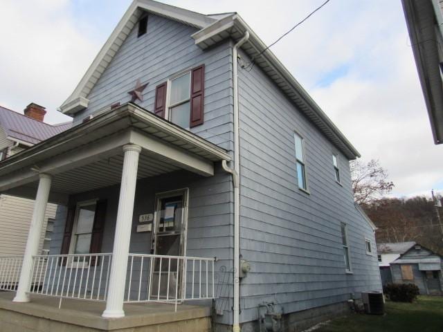 view of side of home featuring central AC unit and a porch