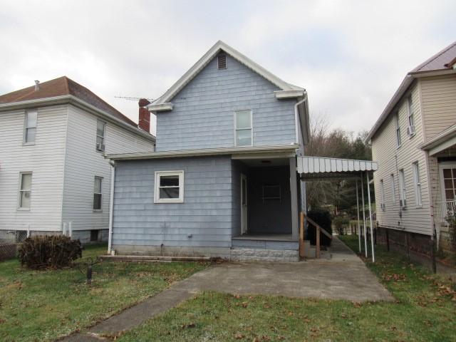 rear view of house with a lawn