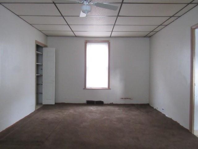 spare room featuring a drop ceiling and ceiling fan