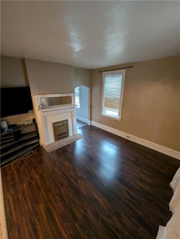 unfurnished living room featuring dark hardwood / wood-style floors