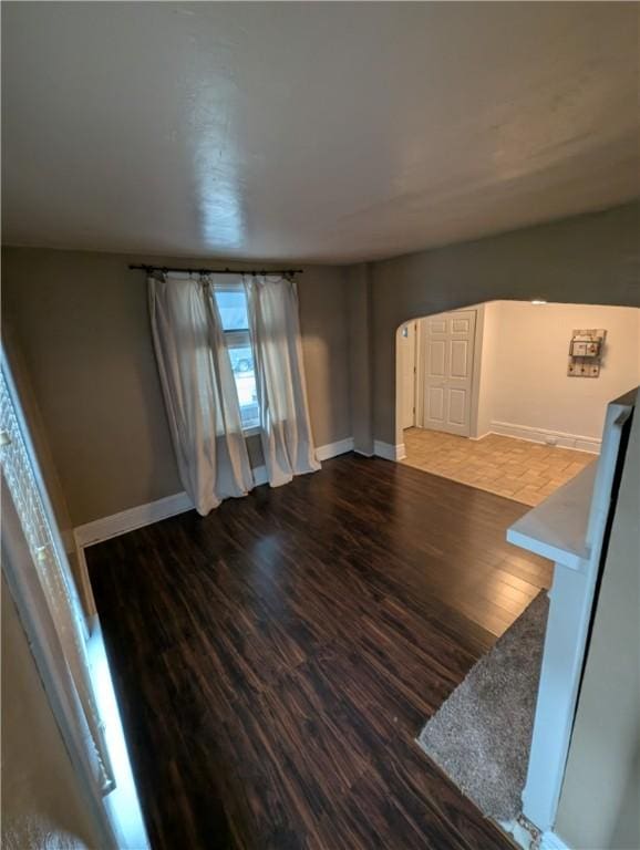 unfurnished living room with wood-type flooring