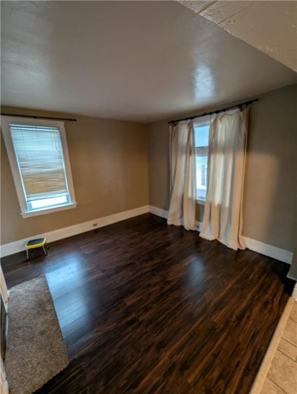 empty room featuring dark wood-type flooring