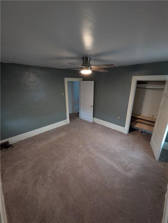 unfurnished bedroom featuring carpet, ceiling fan, and a closet