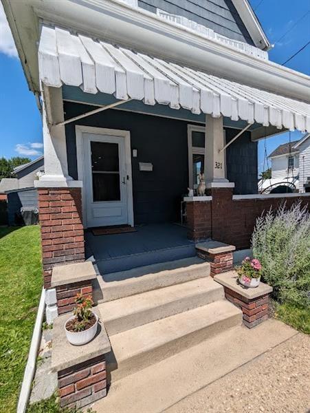 view of exterior entry with a porch