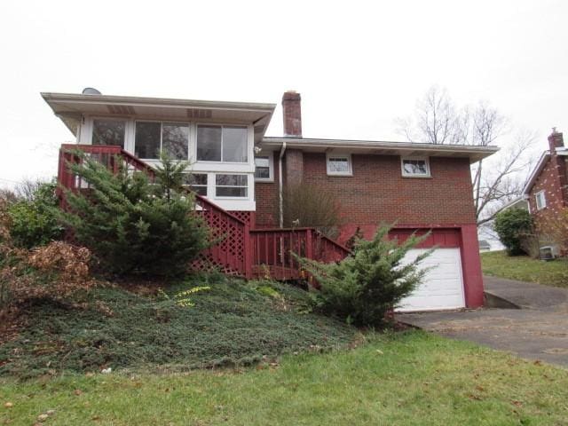 rear view of property with a garage