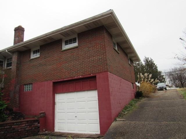 view of side of home with a garage