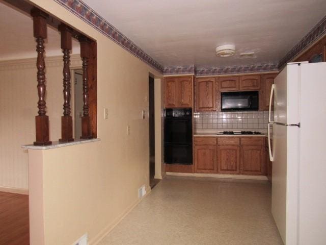 kitchen with black appliances and tasteful backsplash