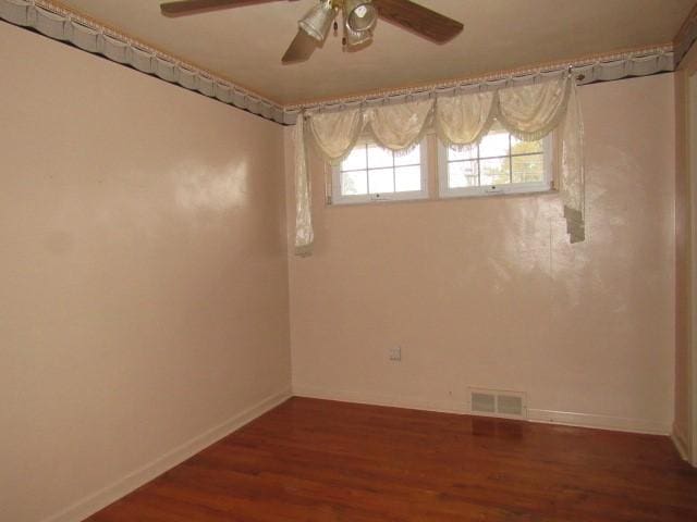 unfurnished room with ceiling fan and dark wood-type flooring