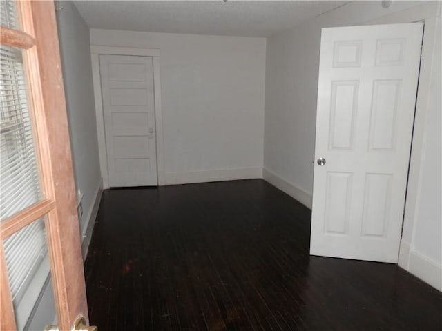 empty room with dark wood-type flooring