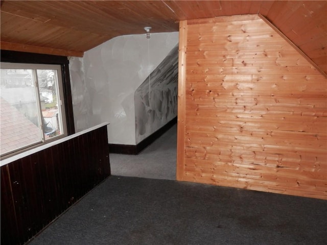 additional living space with vaulted ceiling, wooden walls, and wood ceiling