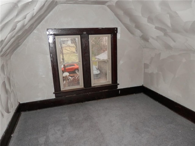 bonus room featuring carpet flooring and vaulted ceiling