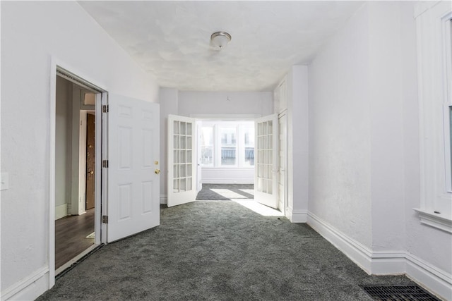 corridor featuring french doors and dark carpet