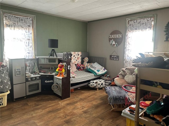 bedroom with crown molding and hardwood / wood-style flooring