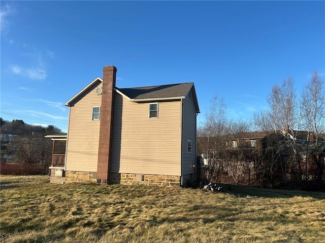 view of side of home featuring a lawn