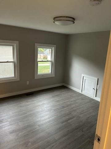 empty room with dark hardwood / wood-style floors