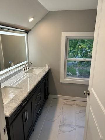 bathroom featuring vanity and vaulted ceiling