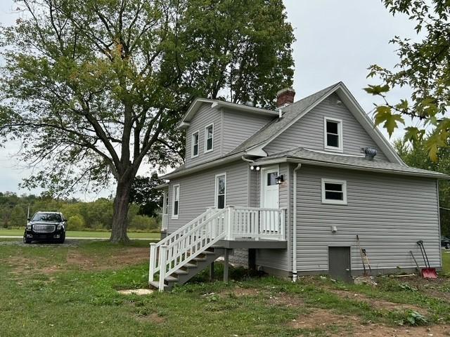 back of property featuring a yard